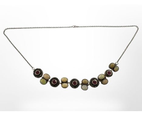 A silver necklace set with opal ruby and diamond