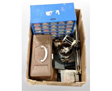 A box containing fishing reels, bait box, hip flask, fisherman's multi-draw storage chest, etc.