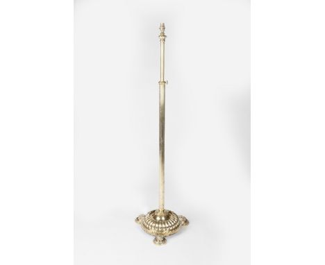An Edwardian brass standard lamp circa 1900 with reeded column over circular base 104cm high.