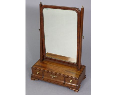 A Queen Anne style mahogany swing dressing table mirror of rectangular form with re-entrant upper corners, on tapered support