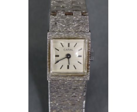 A Caral silver ladies’ bracelet watch with textured surface, the square off-white engine-turned dial with baton numerals.