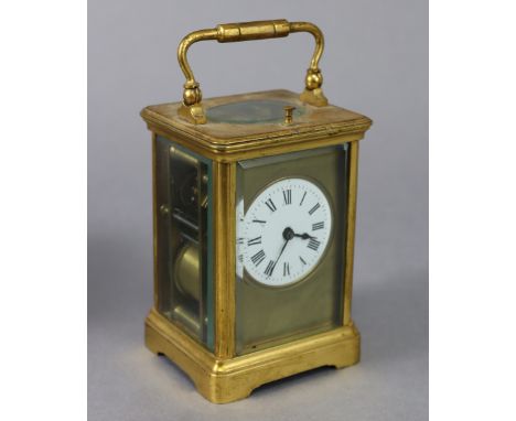 A French carriage clock in gilt-brass case with bevelled glass panels to all sides &amp; top, 2” white enamel dial with black