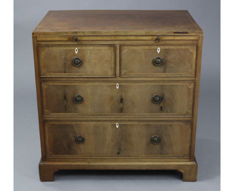 An early 19th century inlaid mahogany small chest of drawers, fitted brushing slide above two short &amp; two long graduated 
