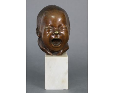 A sculptured bronze bust of an infant, on white marble plinth base; 8½” high over-all.