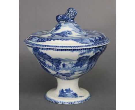 A 19th century pearlware circular tureen &amp; cover with blue transfer decoration, lion finial, &amp; on pedestal foot; 7¾” 