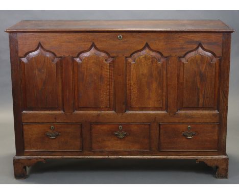 AN 18th century OAK MULE CHEST, with arched four-panel front above three short drawers with brass oval escutcheons &amp; swan
