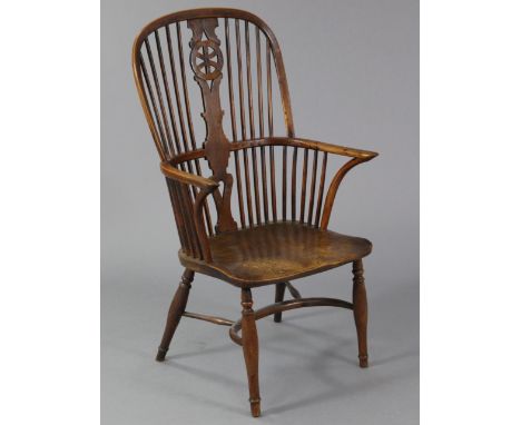 A 19th century yew wood &amp; elm arched-back Windsor armchair, with hooped stick back, curved open arms, shaped saddle seat,