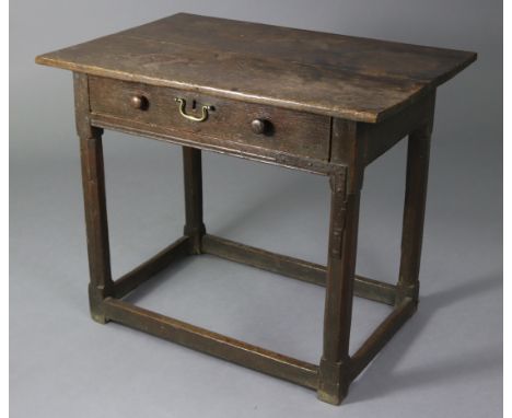 A late 17th century joined oak side table, the two-plank overhang rectangular top above a frieze drawer, on chamfered square 