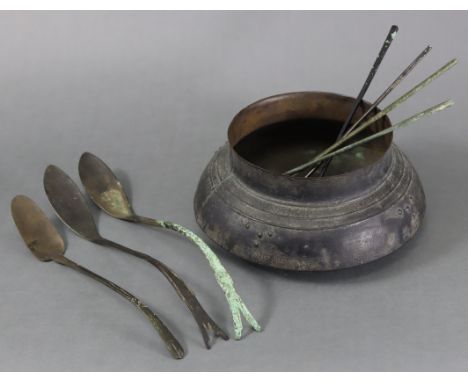 An eastern bronze shallow food vessel, 4” high x 8 ¾” diam., together with seven various bronze eating utensils, possibly Kor
