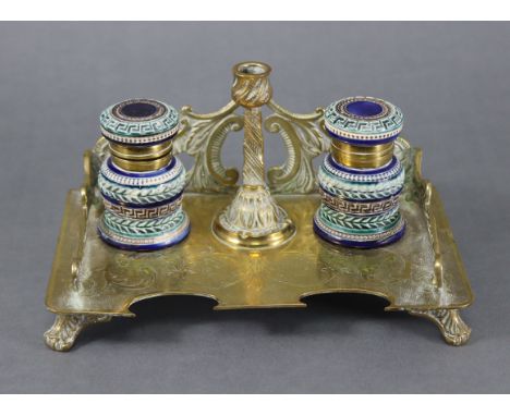 A 19th century brass rectangular inkstand with raised scroll gallery &amp; engraved foliate decoration, with central candle h