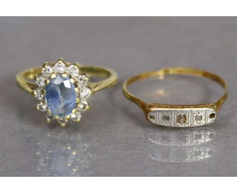 An 18ct. gold ring set oval-cut pale sapphire within a border of small diamonds, size I, (2.5gm); &amp; an 18ct. &amp; platin