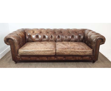 CHESTERFIELD SOFA, brown leather on front castors, 73cm H x 223cm W x 100cm D. 