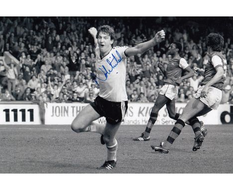 Autographed NORMAN WHITESIDE 12 x 8 photo : B/W, depicting Manchester United's NORMAN WHITESIDE running away in celebration a