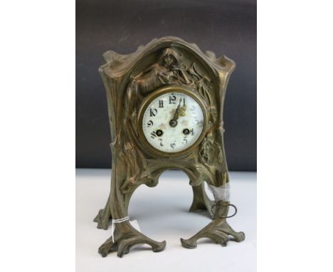 Art Nouveau Gilt Metal Mantle Clock, the case cast with sinuous relief decoration of a lady and flowers, the white enamel fac