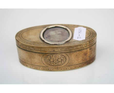 A late 18th century / early 19th century brass snuff box with glass panelled hinged lid.