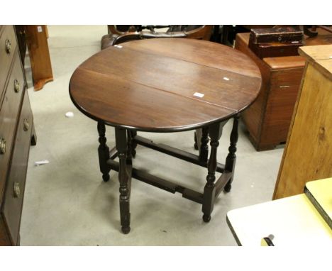 Small Antique Mahogany Oval Gate-leg Table raised on turned baluster and block supports. h.66cms L.82cms