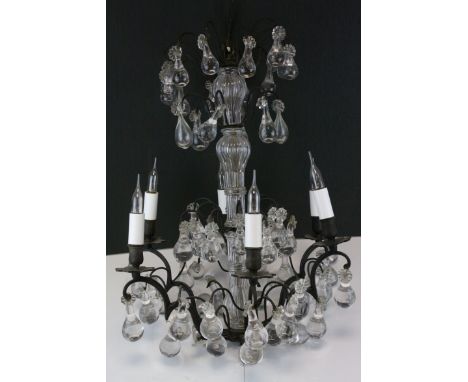 A contemporary candelabra chandelier with glass droplets.