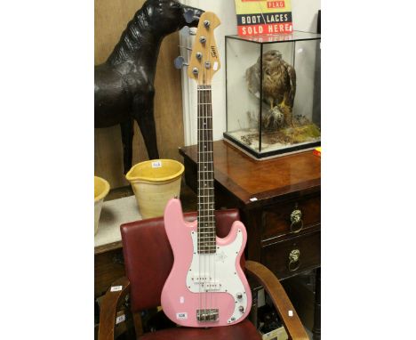 A pink Swift bass guitar .