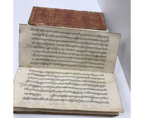 A Tibetan manuscript in lacquered vellum boards 40 x 17 x 6 cm deep
