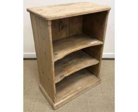 A Victorian pine open shelf unit of three tiers on a plinth base 66 cm wide x 35 cm deep x 90.5 cm high together with a carve