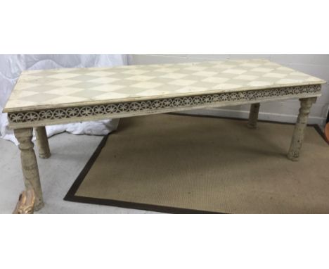 A modern Indian painted hardwood dining table, the rectangular lozenge painted cream/grey top over a carved frieze on turned 