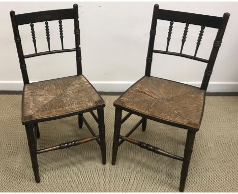 A set of six William Morris style Arts & Crafts rush seat spindle back dining chairs on faux bamboo turned legs united by str