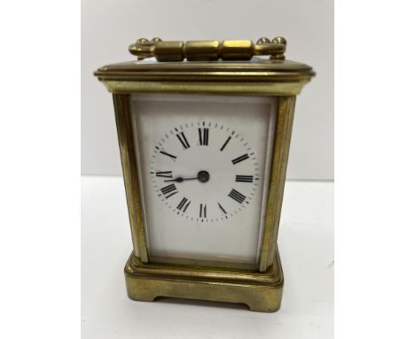 A brass cased carriage clock of small proportions, the movement by Diette Hour with white enamelled dial and Roman numerals t