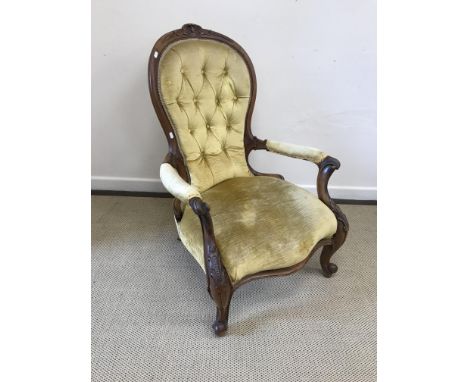 A Victorian spoon back salon armchair with yellow button back upholstery, 100 cm high, 