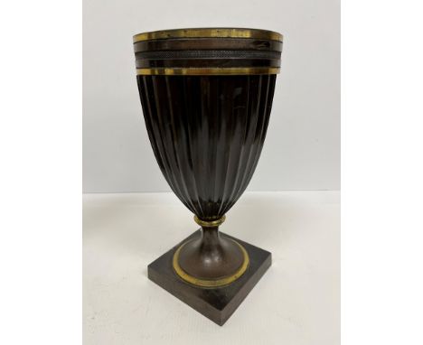 A 19th Century chocolate patinated bronze and gilt brass banded oil lamp base of fluted goblet form, raised on a square foot,