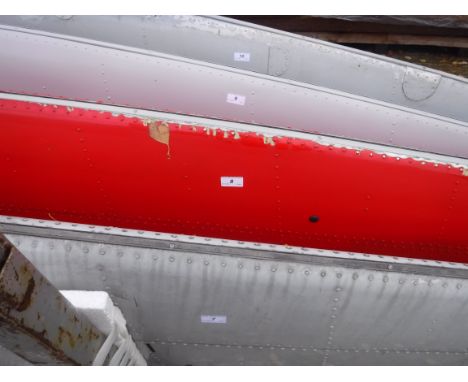 A pale grey painted aircraft tail fin section, bearing tag inscribed "....Serial No. DH/R/505....."