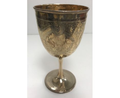 A Victorian silver trophy cup with engraved decoration and inscribed "Presented by Lord R Churchill MP for the Best Ten Oxfor