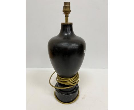 A black marble urn shape table lamp with Classical style decoration of figures and foliate sprays on a circular white veined 