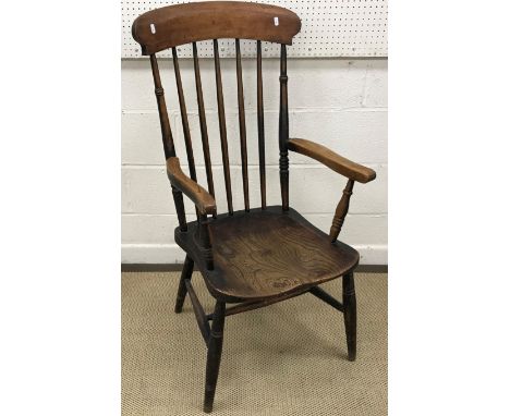 A Victorian beech and elm stick back elbow chair on turned legs united by an H stretcher together with a painted metal framed