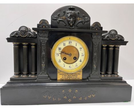 A circa 1900 black marble cased architectural mantle clock with column decoration and eight day French movement with circular