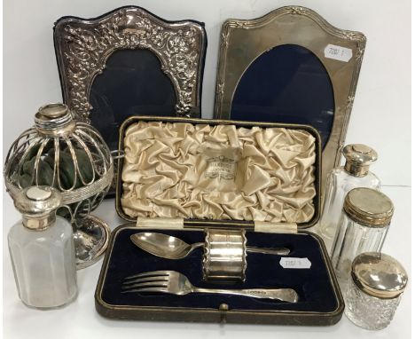 A collection of silver and plated items to include two silver mounted photo frames, one in the Edwardian taste with embossed 