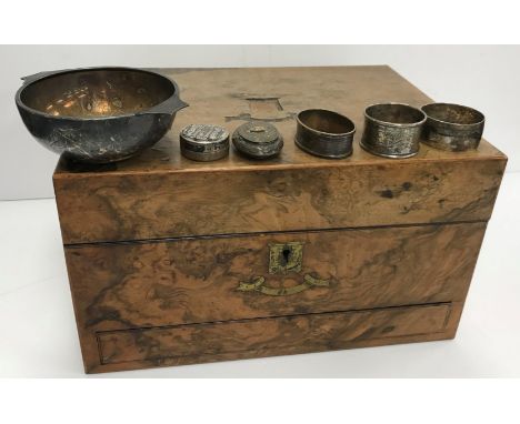 Two silver napkin rings, a niello decorated napkin ring and a white metal circular lidded box with Egyptian style decoration 