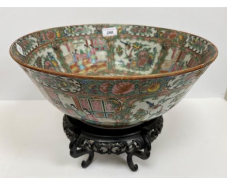 A 19th Century Chinese famille rose fruit bowl with slightly flared rim and carved wooden stand, the main body decorated with