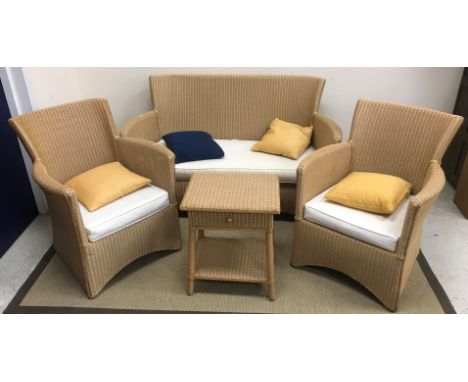 A Lloyd Loom style three piece conservatory suite of two seat sofa, 140 cm wide and pair of armchairs, 67 cm wide, together w