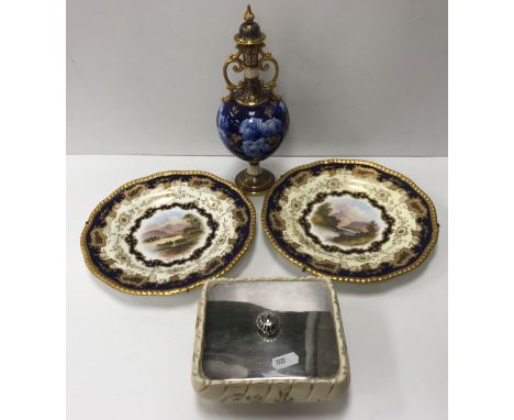 A Royal Doulton twin handled lidded vase No'd RA5625 to base, the blue ground with rose decoration and applied gilt foliate s