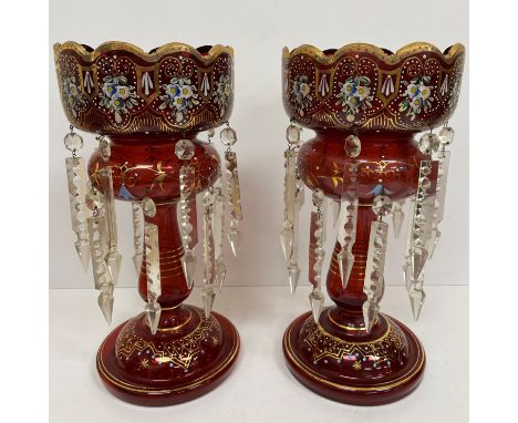 A pair of ruby glass table lustres with painted floral and gilded decoration, the drops of clear cut form 17 cm diameter x 35