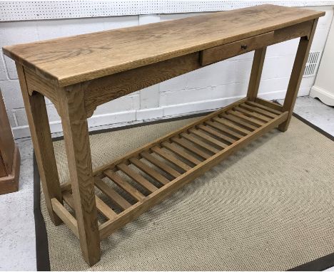 A modern oak side table, the plain top above a single frieze drawer on square supports united by a slatted pot shelf (ex Cran