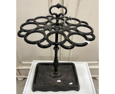 A Victorian style cast iron eight section stick stand of oval form on a centre column to the rectangular drip tray 38 cm wide