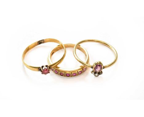 A synthetic ruby half hoop ring, stamped '750', finger size K1/2; an adapted 22 carat gold band ring, finger size R; and a pi