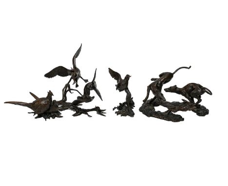 A bronze sculpture depicting two greyhounds chasing a hare 'Waterloo Cup 2005' artist M Tahir; together with a further four b