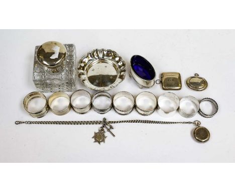 A Collection of Assorted Silver, including: a silver-mounted glass inkwell; a shaped circular silver dish; 9 various napkin-r