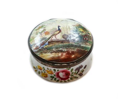 An 18th century Birmingham enamel circular box with hinged cover, painted with a peacock in a country house garden landscape 