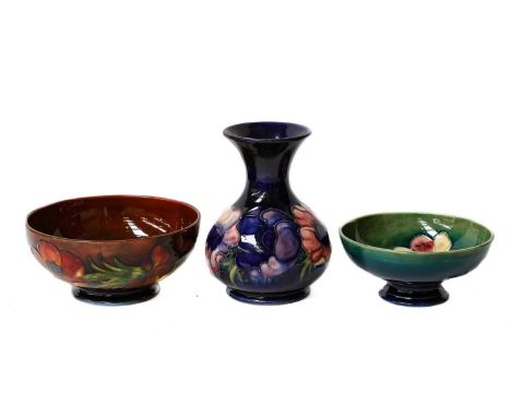 A small collection of Moorcroft, including a blue vase (a.f), two shallow bowls, a case enamel pillbox, and an enamel vase an