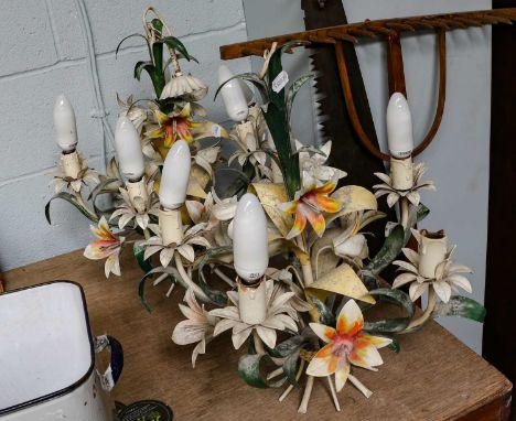 A pair of painted metal five-light candelabra in the form of flowers