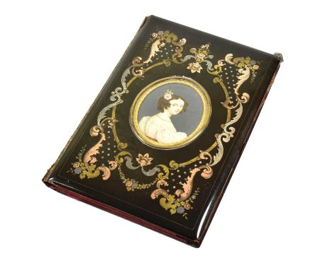 A Victorian Gilt-Metal Inlaid Notebook, oblong, the cover inlaid with vari-coloured metal foliage and flowers, centring a por