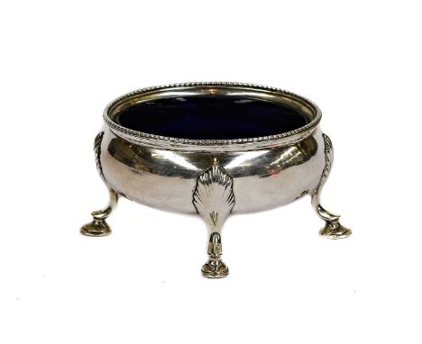 A George III Silver Salt-Cellar, by Hester Bateman, London, 1784, oval and on four shell-capped scroll and pad feet, with bea